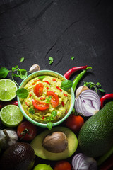 Background bowl guacamole tomato chilli pepper lime onion garlic dill and oregano