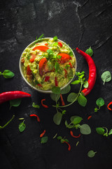 bowl guacamole tomato chilli pepper lime onion garlic dill and oregano