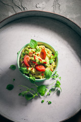 bowl guacamole tomato chilli pepper lime onion garlic dill and oregano