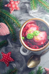Christmas Eve red borscht dumplings Decorated table cutlery green twigs