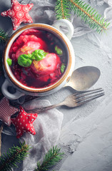 Red borscht dumplings Christmas table place text cutlery