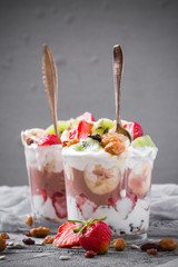 Yoghurt fruit dessert strawberries banana kiwi raisins sunflower seeds oatmeal walnuts caramel