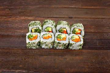 Sushi rolls on a wooden table