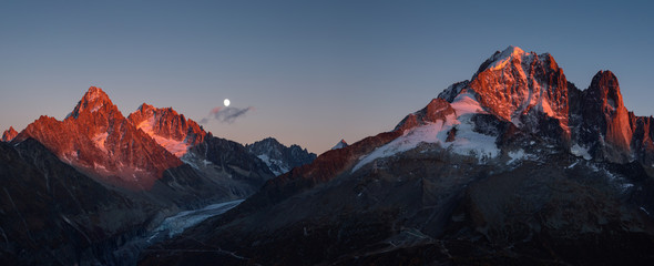 Plakat Panorama of the last sunlight on the mountain peaks near Chamonix, France, during moonrise.
