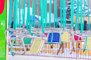 empty seats of childrens carousel in amusement park