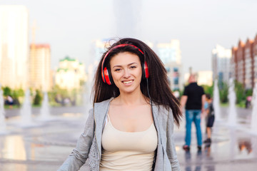 Girl listening to music streaming with headphones.