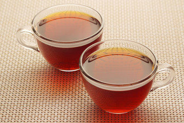 Two glass cups with black tea