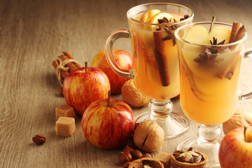 Two cups with hot cider in cold season with cinnamon and anise
