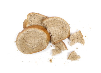 Integral bread slices with crumbs isolated on white background, top view