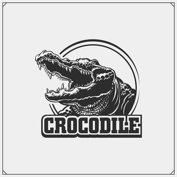 The emblem with crocodile. Vector monochrome illustration.