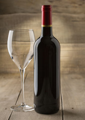 Bottle of dry red wine with a glass