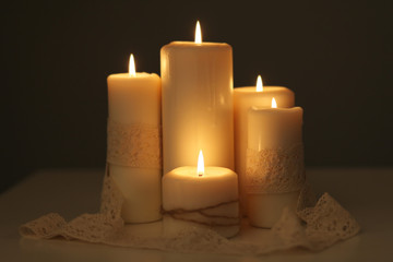 Candles light. Christmas candles burning at night. Abstract candles background. Golden light of...