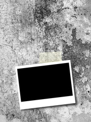 Blank rectangular instant photo frame on weathered concrete wall background