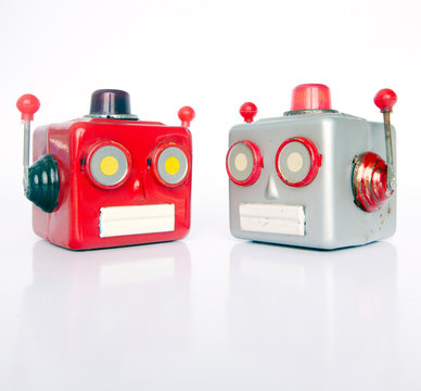 two retro robot heads chatiing isolated
