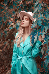 Fototapeta na wymiar Young woman with hat day dreaming in nature
