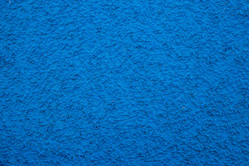 Fototapeta na wymiar Running track sports texture. Running track rubber cover. Tartan track material is the trademarked all-weather synthetic track surfacing for athletics made of polyurethane.Blue tartan athletic running