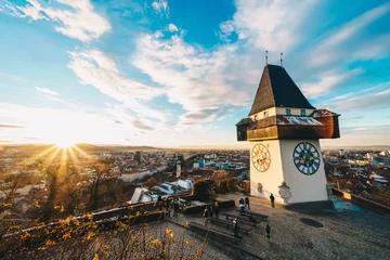 Meubelstickers Graz clock tower and city symbol on top of Schlossberg hill at sunset © Calin Stan