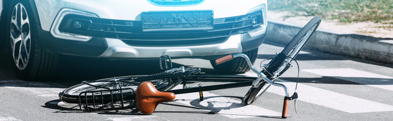 close up view of broken bicycle and car on road, car accident concept