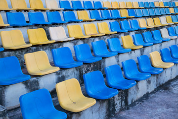 seats at the stadium.  plastic spectator seats in stadium, competition concept. old plastic seats at stadium. 