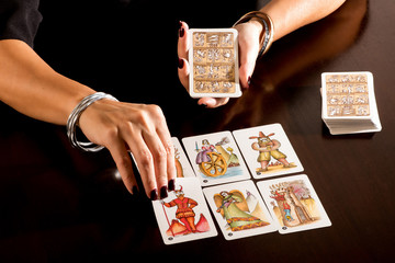 Fortune teller reading a deck of Tarot Cards - obrazy, fototapety, plakaty