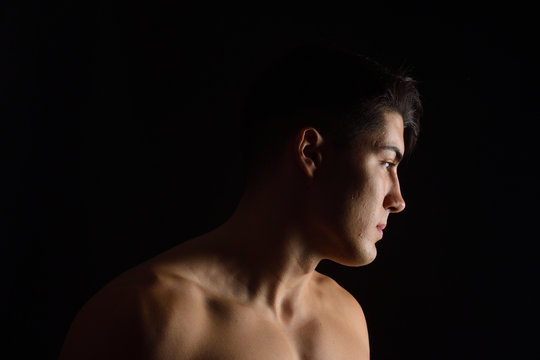 portrait of a man without clothes black background
