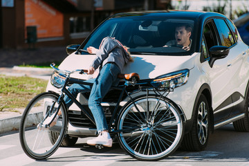 young woman got mowed down by car while driving bicycle on road, car accident concept
