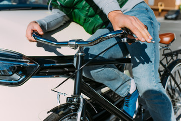 partial view of male bicycle rider hit by car on road, car accident concept