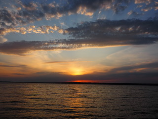 Fototapeta premium Sunset. On the big river. Coast. Beautiful clouds. Summer. Russia, Ural, Perm region