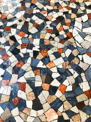 Checkered patchwork floor as pavement in Rome, Italy.