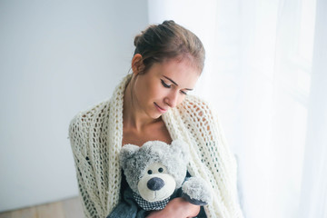 Young beautiful woman holding teddy bear plush for Valentine's Day