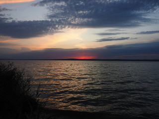 Sunset. On the big river. Beautiful sky. Tree and leaves. Summer. Russia, Ural, Perm region