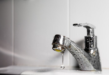 Faucet or tap and water drop pouring in bathroom .