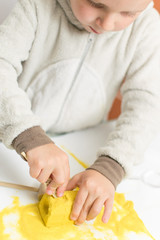 Educational games for children. A little boy plays in archaeological excavations.