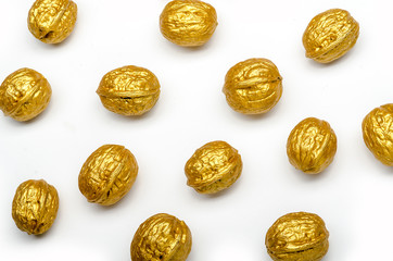 some golden walnuts on a white background