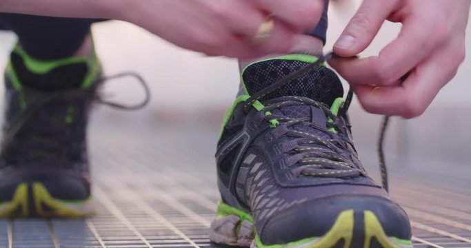 Woman tying her shoes before running.