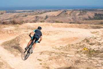 Mountain biker speeding downhill on a mountain bike track