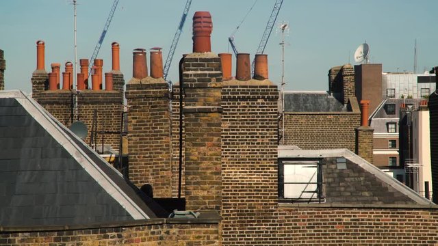 Tranquil skies float above the layered chimneys and smokestacks of London.