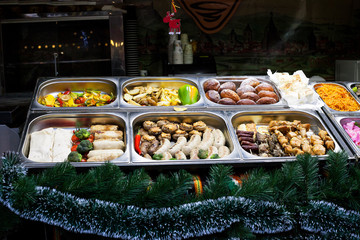 Street food. Potatoes, vegetables, sausages, kebabs on market