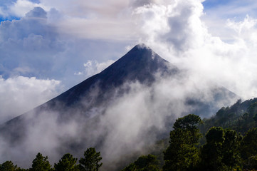 Volcano Fuego covered by clouds and mist. Natural background.