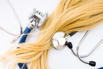 Medical concept in trichology, dermatology and hair examination. Curl or lock of blonde hair of...