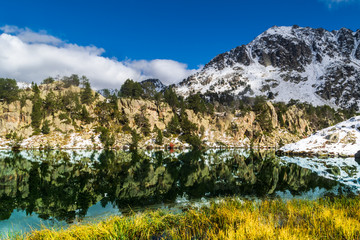 Paisaje nevado en el Parque Nacional de Aiguestortes, Cataluña, España. Lago glaciar que refleja la montaña nevada de alrededor