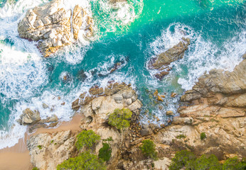 Beach full of rocks and waves in Spain