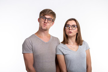 People and education concept - Two young funny student with thoughtful faces over white background