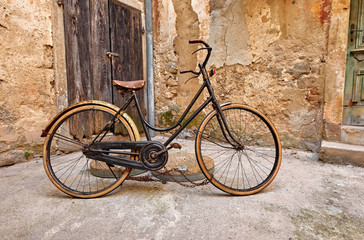 Fototapeta na wymiar Old retro bicycle on vintage street in Croatia background aged