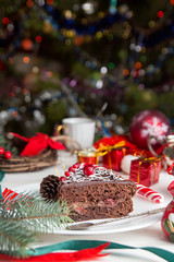 Fototapeta na wymiar Slice of sweet chocolate cake for Christmas Eve.