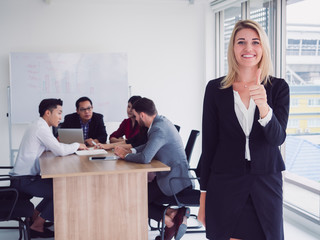 business people in meeting room,Business team explaining new business ideas,businesswoman posing thump up in room