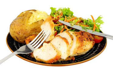 Chicken and baked potato meal with fresh salad isolated on a white background