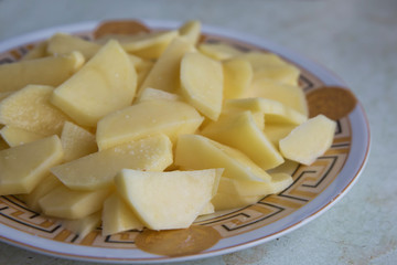 Chopped potatoes. In the chopped potato plate . Sliced, peeled raw potatoes on a board . Chopped potatoes in a bowl . Diced potatoes - as an ingredient to a potato based dish