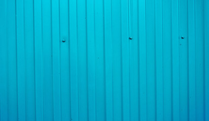 Blue color corrugated metal sheet with leaf shadow background