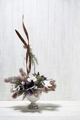 Festive composition of Christmas decorations on white wooden background.